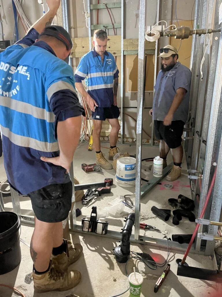 reliable plumber logan fixing pipes inside wall frame